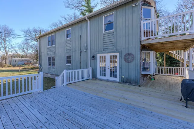 a view of backyard with deck and wooden floor