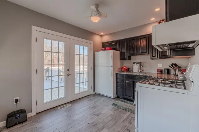a kitchen with stainless steel appliances granite countertop a refrigerator and a stove top oven