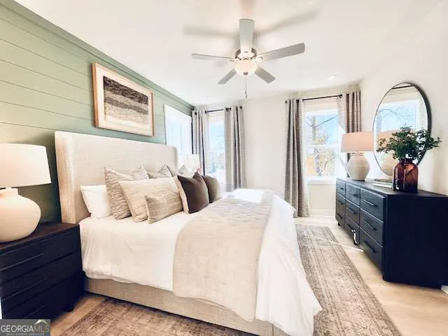 a bedroom with bed and wooden floor