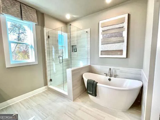 a spacious bathroom with a bathtub and next to a window