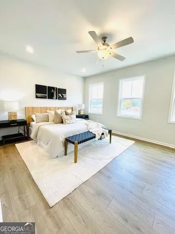 a bedroom with a bed and wooden floor