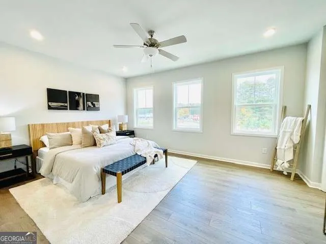 a bedroom with a bed and wooden floor