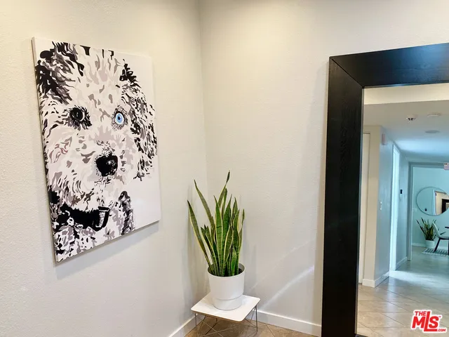 a living room with a couch and a potted plant