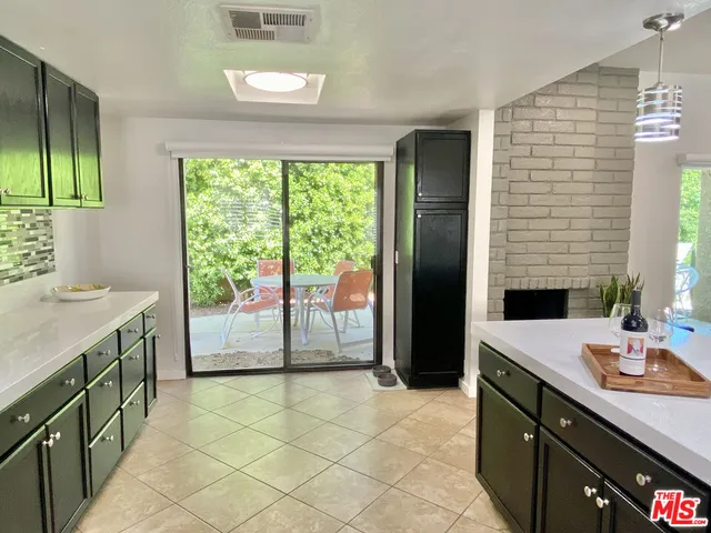 a outdoor living room with furniture and a potted plant