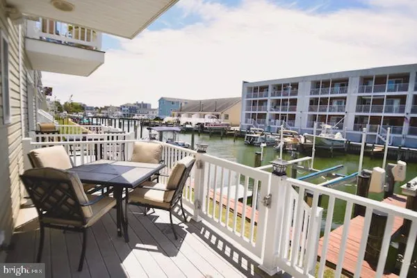 a view of a chairs and table on the balcony