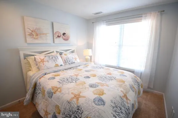 a bedroom with a bed and a night stand