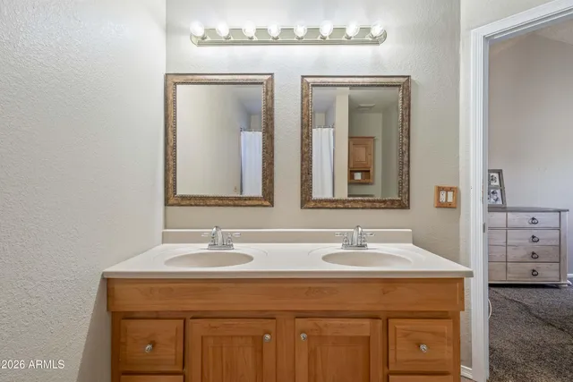 a bedroom with bed and large windows