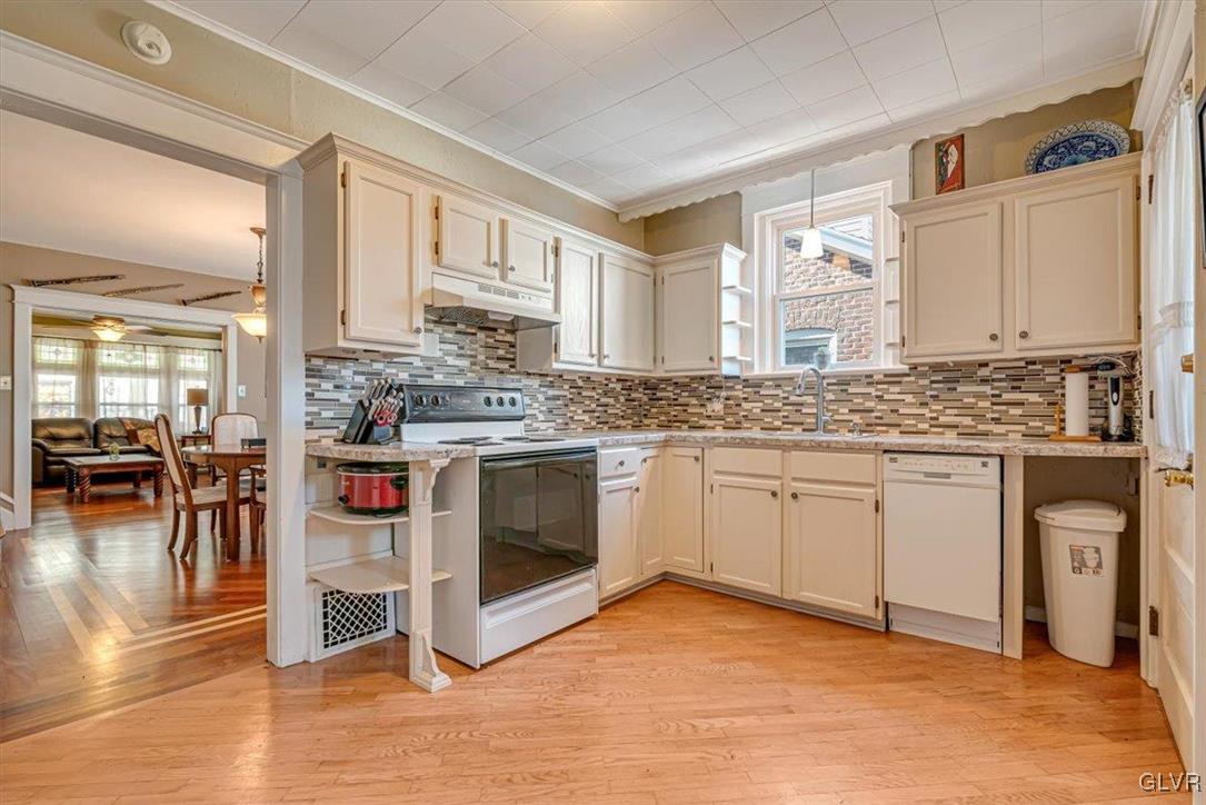 2107 Walbert Avenue Allentown, PA 18104 - Photo 15 of 55 a kitchen with stainless steel appliances granite countertop a stove a sink and white cabinets