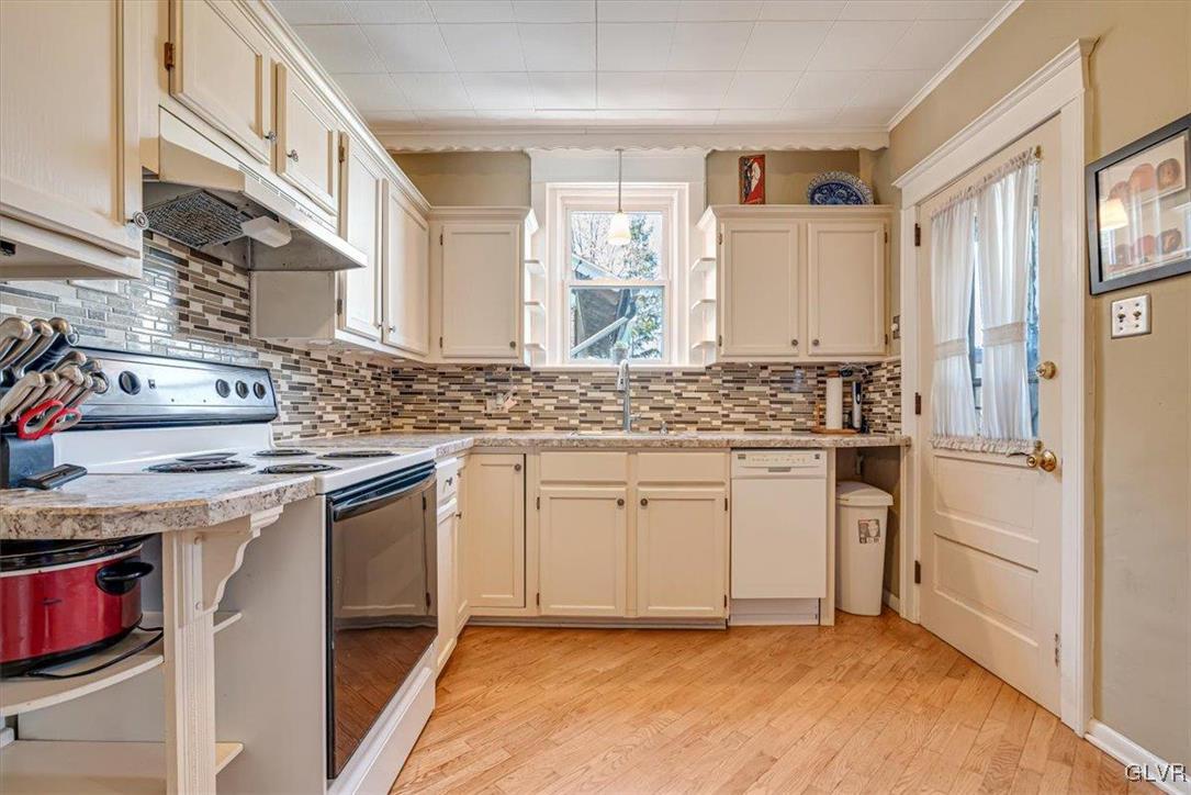 2107 Walbert Avenue Allentown, PA 18104 - Photo 16 of 55 a kitchen with granite countertop white cabinets sink and stainless steel appliances