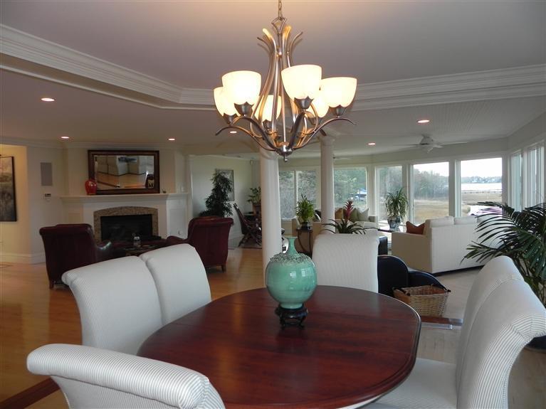 157 Monomoscoy Road Mashpee, MA 02649 - Photo 12 of 28 a living room with fireplace furniture and a chandelier