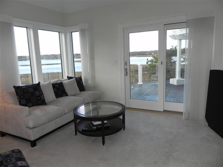 157 Monomoscoy Road Mashpee, MA 02649 - Photo 15 of 28 a living room with furniture and a flat screen tv