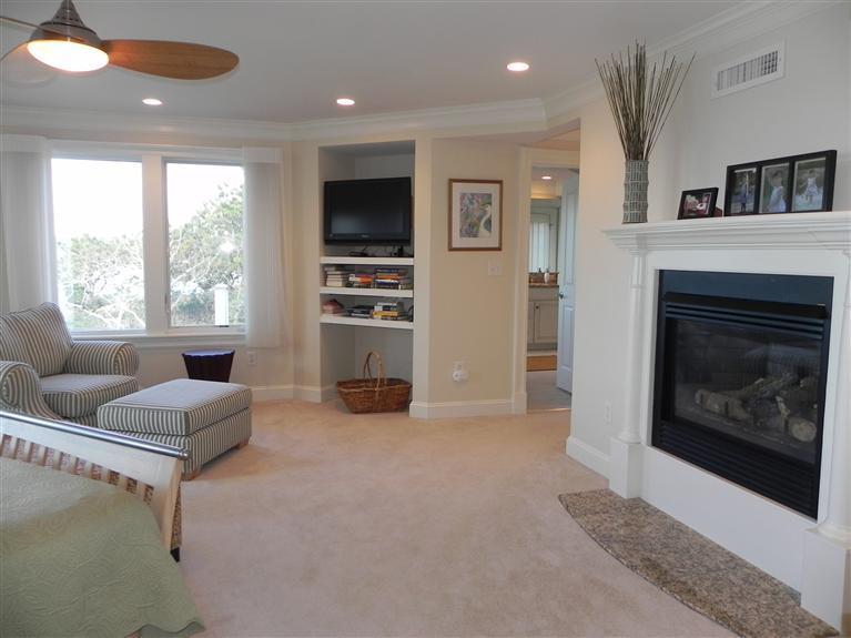 157 Monomoscoy Road Mashpee, MA 02649 - Photo 20 of 28 a living room with furniture a flat screen tv and a fireplace