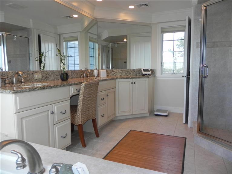 157 Monomoscoy Road Mashpee, MA 02649 - Photo 22 of 28 a spacious bathroom with a granite countertop sink mirror and a