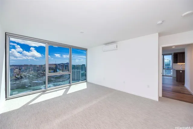 a view of empty room with wooden floor and floor to ceiling window
