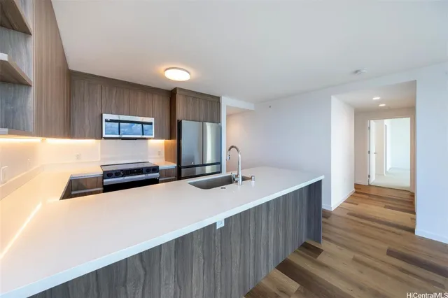 a kitchen with stainless steel appliances a sink and a refrigerator