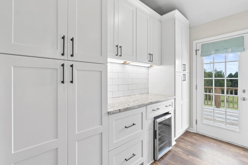 1214 Roxey Maxey Road Southwest Winder, GA 30680 - Photo 11 of 35 a view of a kitchen with white cabinets and wooden floor