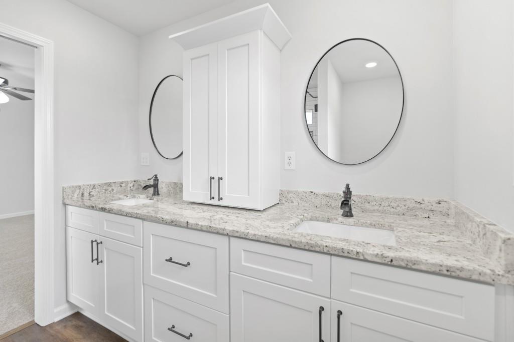 1214 Roxey Maxey Road Southwest Winder, GA 30680 - Photo 24 of 35 a bathroom with 2 sink and a mirror