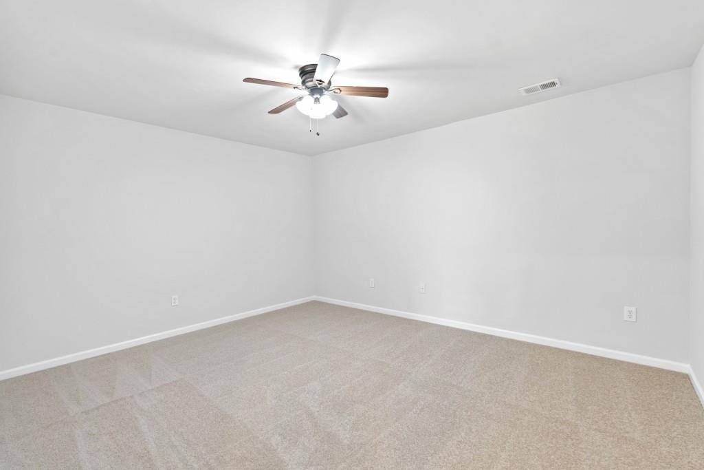 1214 Roxey Maxey Road Southwest Winder, GA 30680 - Photo 27 of 35 a view of an empty room with a chandelier fan