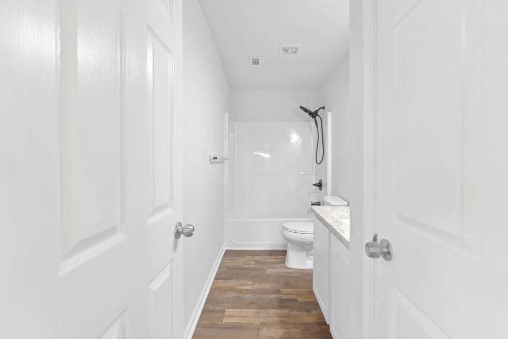 1214 Roxey Maxey Road Southwest Winder, GA 30680 - Photo 28 of 35 a bathroom with a sink a toilet and shower