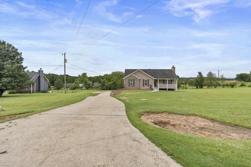 1214 Roxey Maxey Road Southwest Winder, GA 30680 - Photo 35 of 35 a view of a house with a big yard potted plants and a big yard