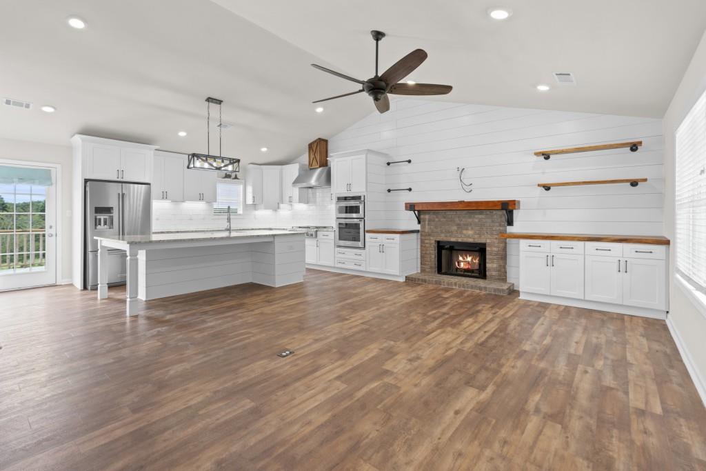 1214 Roxey Maxey Road Southwest Winder, GA 30680 - Photo 4 of 35 a view of a kitchen with a sink and a fireplace