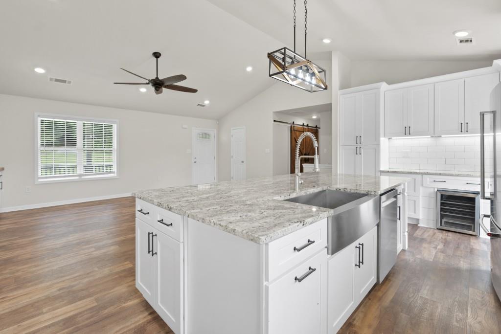 1214 Roxey Maxey Road Southwest Winder, GA 30680 - Photo 10 of 35 a kitchen with stainless steel appliances granite countertop a sink stove and refrigerator