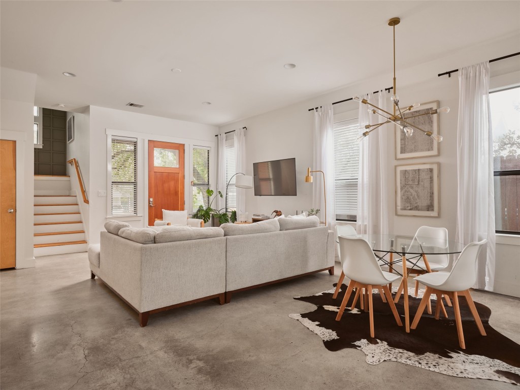 2002 East 13th Street, Unit A Austin, TX 78702 - Photo 11 of 37 Living room featuring finished concrete floors, stairs, healthy amount of natural light, and recessed lighting