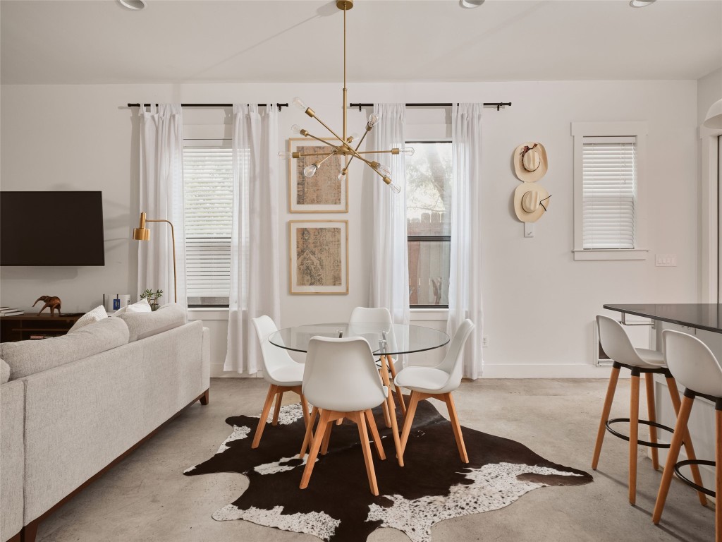 2002 East 13th Street, Unit A Austin, TX 78702 - Photo 12 of 37 Dining room featuring a chandelier, concrete floors, and recessed lighting