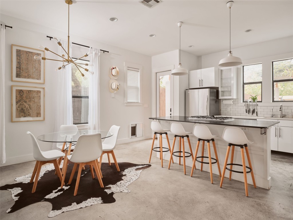 2002 East 13th Street, Unit A Austin, TX 78702 - Photo 14 of 37 Dining area with concrete floors, a chandelier, and recessed lighting