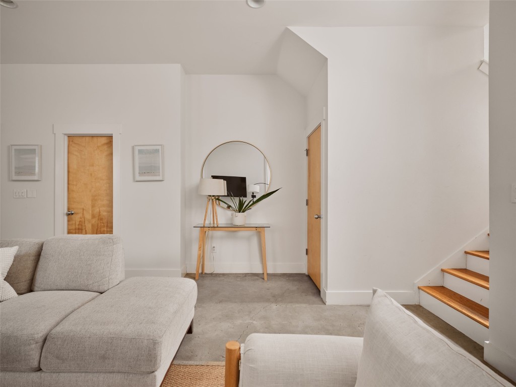 2002 East 13th Street, Unit A Austin, TX 78702 - Photo 18 of 37 Living room featuring concrete flooring and stairs