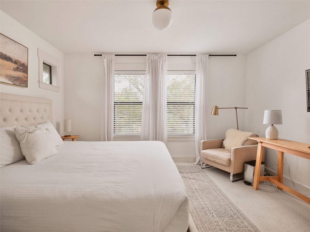2002 East 13th Street, Unit A Austin, TX 78702 - Photo 23 of 37 Bedroom with light colored carpet and baseboards