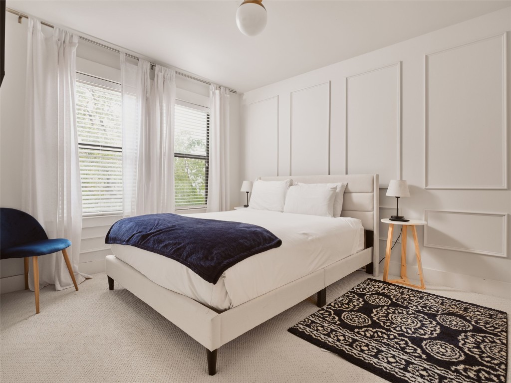 2002 East 13th Street, Unit A Austin, TX 78702 - Photo 26 of 37 Bedroom featuring a decorative wall and carpet floors