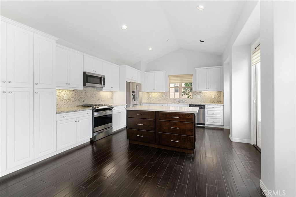86 Townsend Irvine, CA 92620 - Photo 13 of 48 a kitchen with stainless steel appliances kitchen island granite countertop a stove a sink and a refrigerator