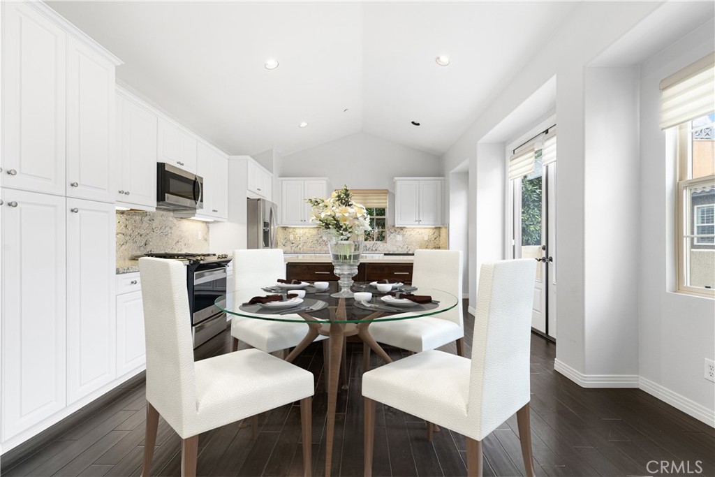 86 Townsend Irvine, CA 92620 - Photo 4 of 48 a kitchen that has a table chairs and a refrigerator