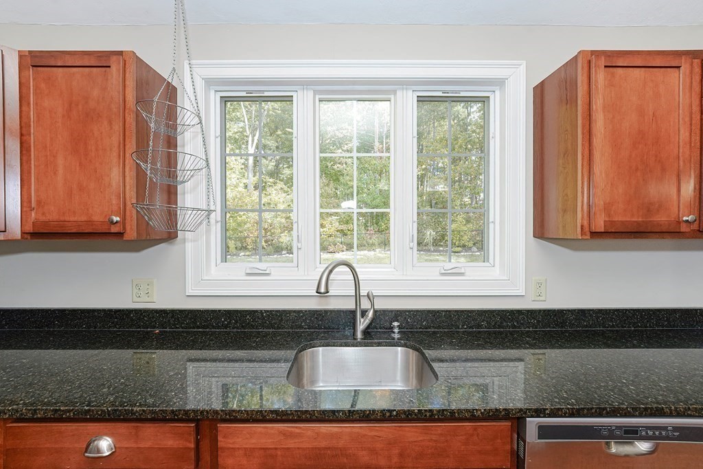 71 Snake Hill Road Ayer, MA 01432 - Photo 11 of 36 a kitchen with granite countertop a sink and a window