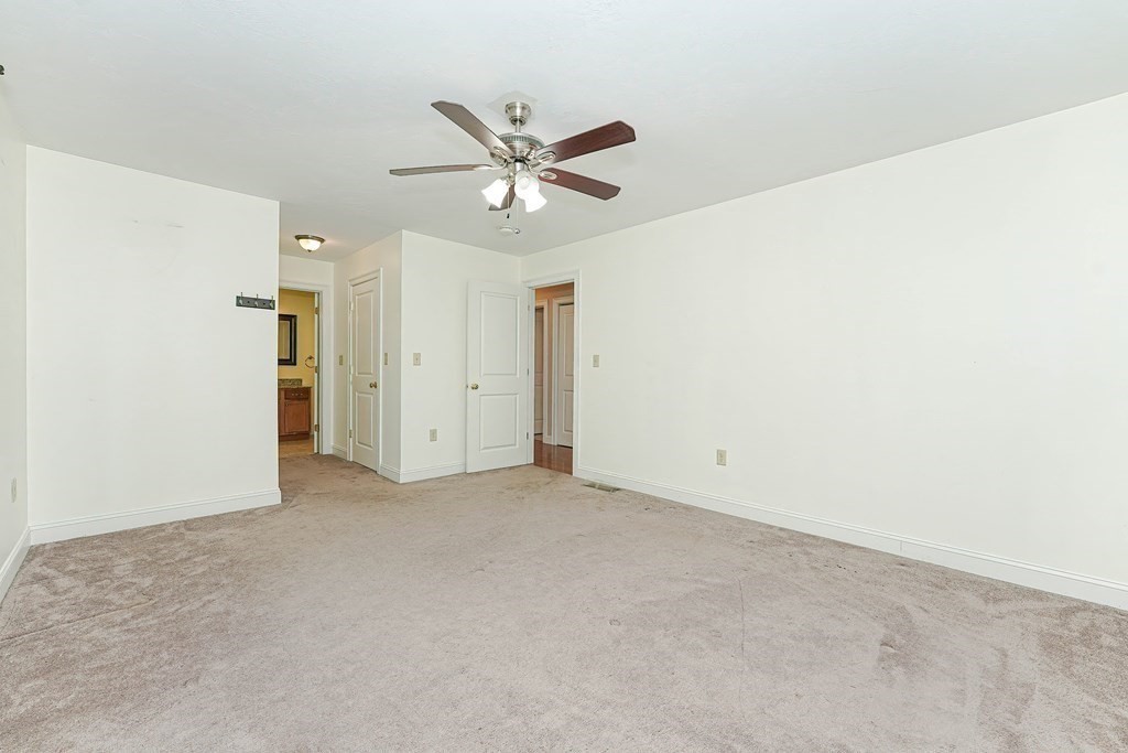 71 Snake Hill Road Ayer, MA 01432 - Photo 17 of 36 an empty room with a ceiling fan and a window