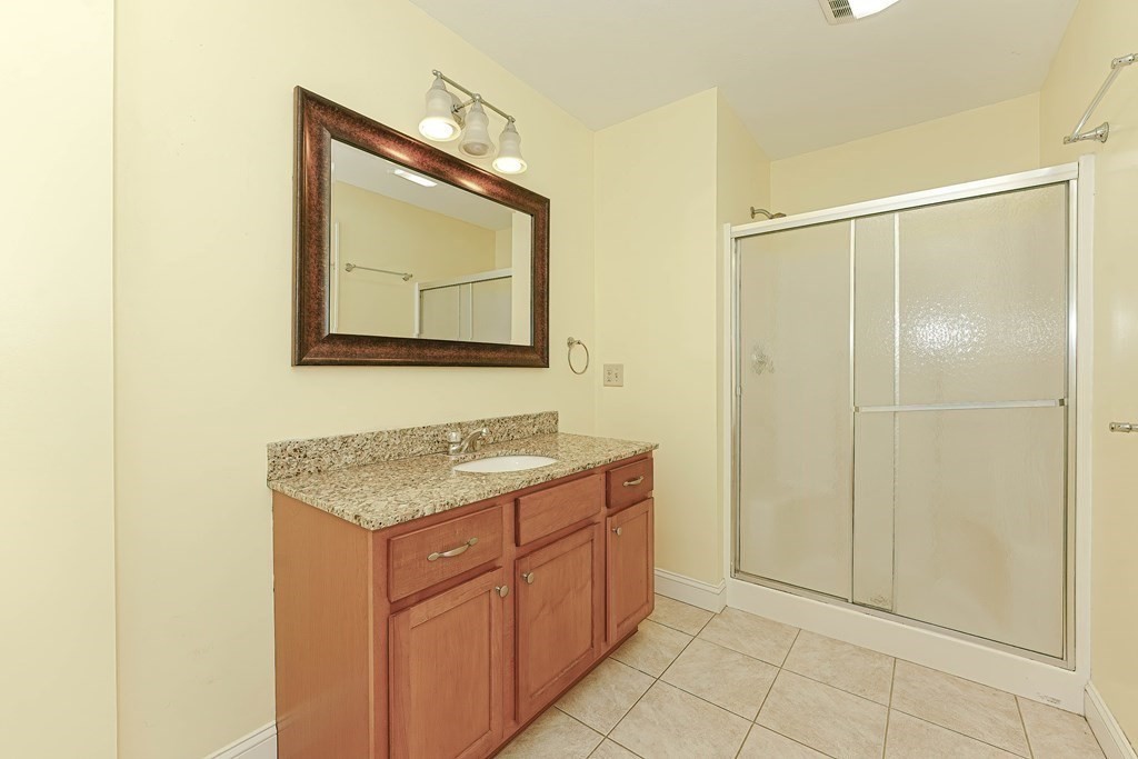 71 Snake Hill Road Ayer, MA 01432 - Photo 19 of 36 a bathroom with a granite countertop sink mirror and
