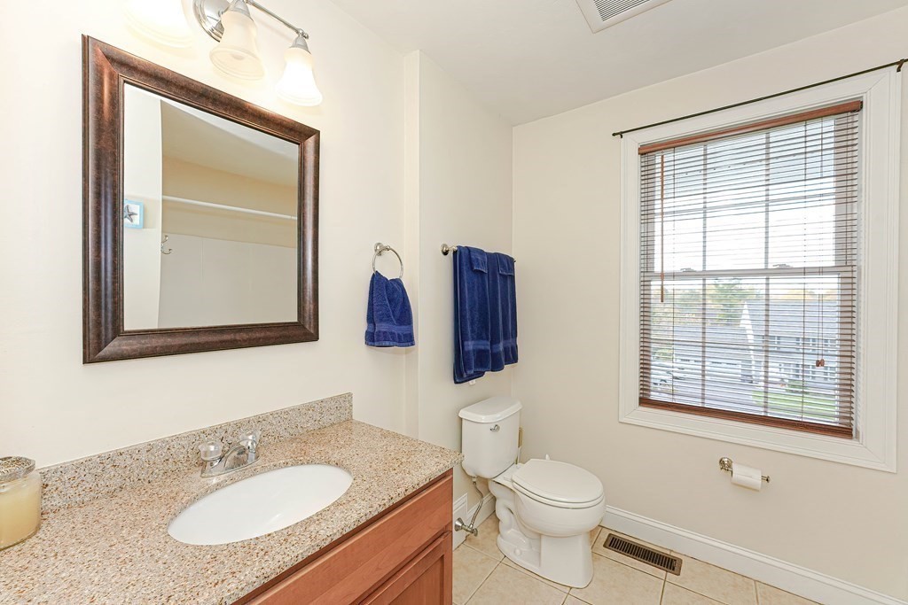 71 Snake Hill Road Ayer, MA 01432 - Photo 23 of 36 a bathroom with a granite countertop sink toilet and mirror