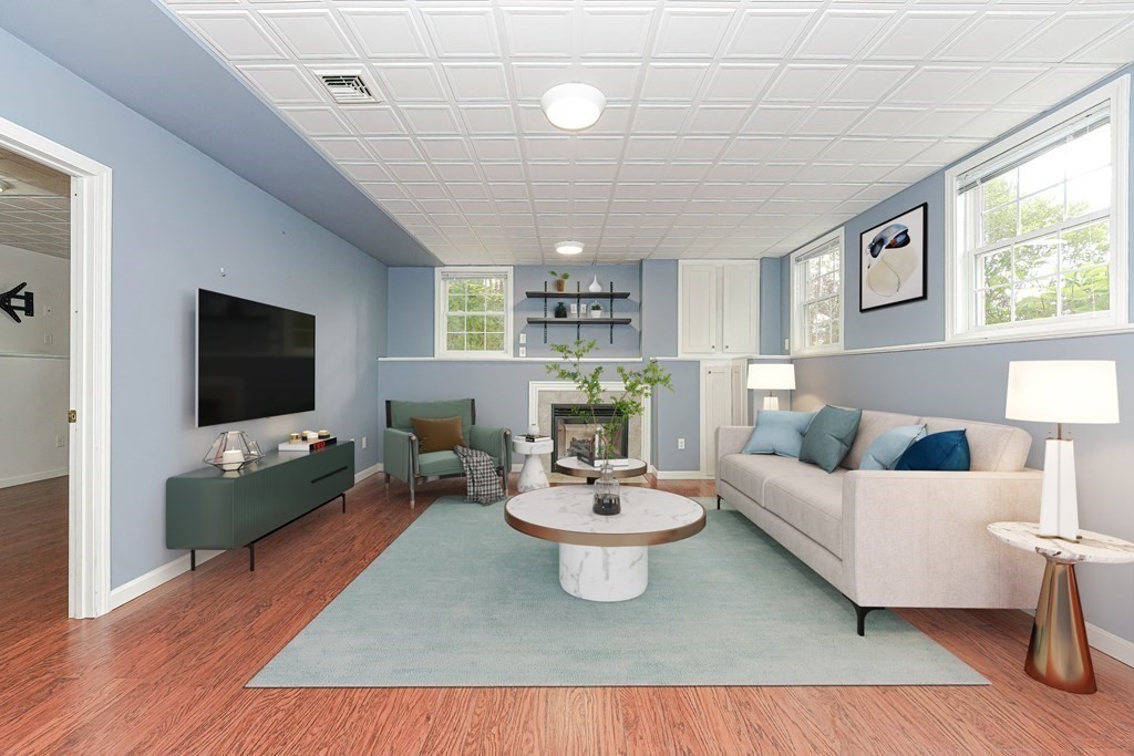 71 Snake Hill Road Ayer, MA 01432 - Photo 27 of 36 a living room with furniture a flat screen tv and a large window