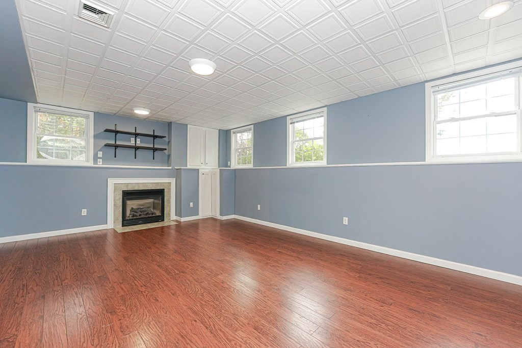 71 Snake Hill Road Ayer, MA 01432 - Photo 28 of 36 an empty room with windows and a fireplace