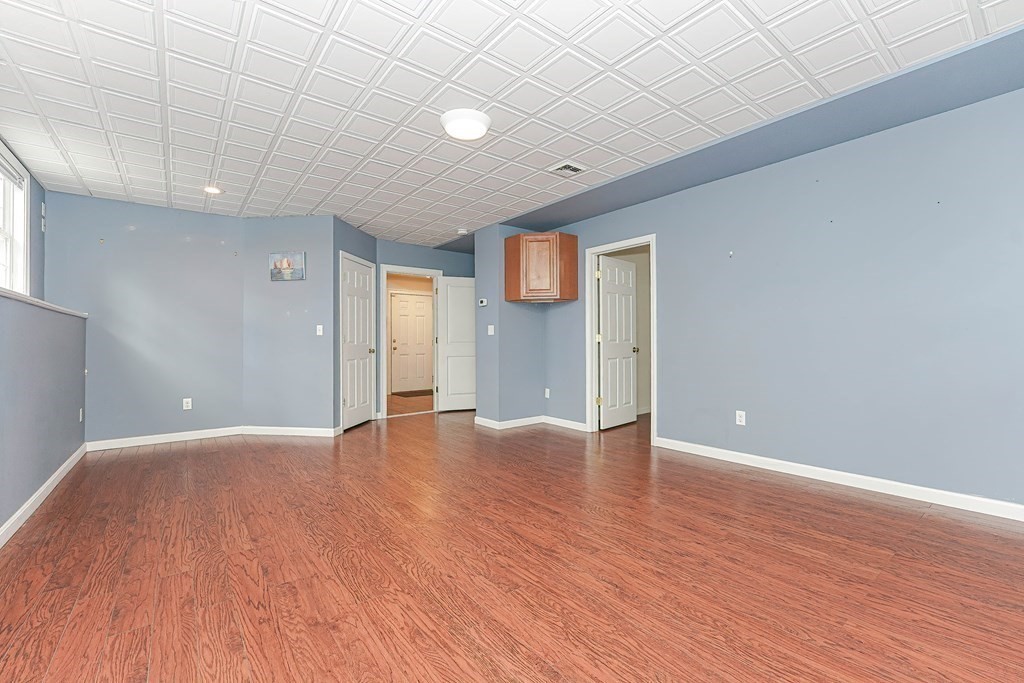 71 Snake Hill Road Ayer, MA 01432 - Photo 29 of 36 a view of an empty room with wooden floor