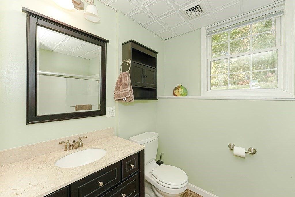 71 Snake Hill Road Ayer, MA 01432 - Photo 30 of 36 a bathroom with a sink a toilet and mirror