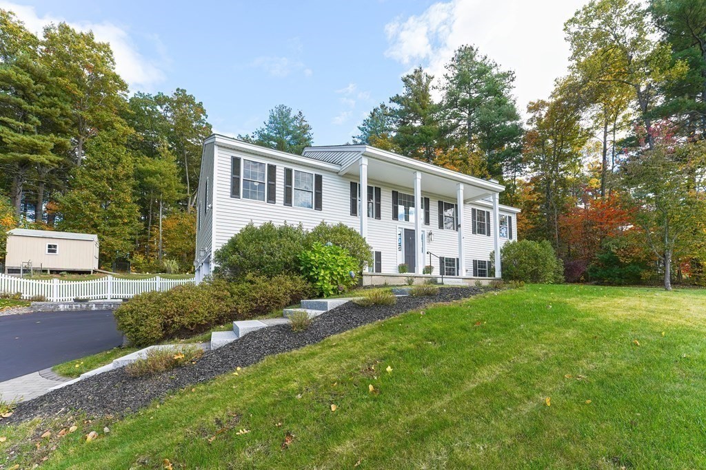 71 Snake Hill Road Ayer, MA 01432 - Photo 3 of 36 a front view of a house with a yard and trees
