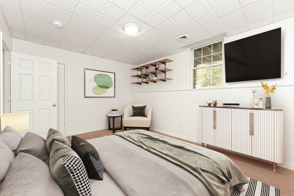 71 Snake Hill Road Ayer, MA 01432 - Photo 32 of 36 a bedroom with a bed and a flat screen tv
