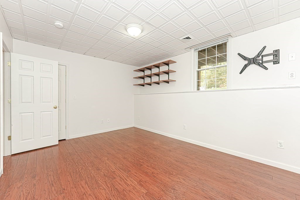 71 Snake Hill Road Ayer, MA 01432 - Photo 33 of 36 an empty room with wooden floor and windows