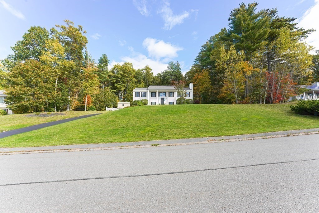 71 Snake Hill Road Ayer, MA 01432 - Photo 4 of 36 a view of a house with a big yard and large trees