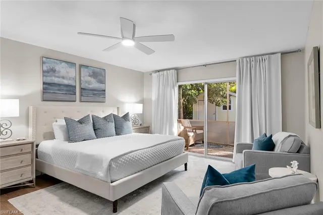 a bedroom with a bed couch and window