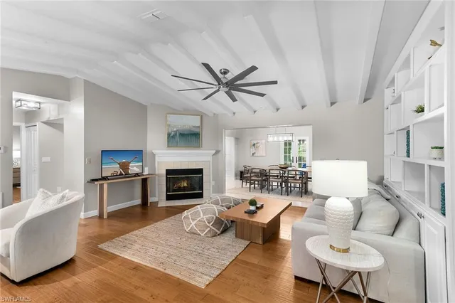 a living room with furniture a fireplace and a table