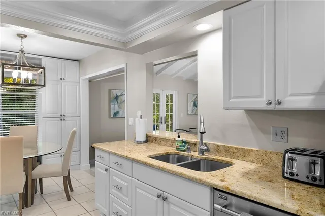 a kitchen with granite countertop a sink and cabinets