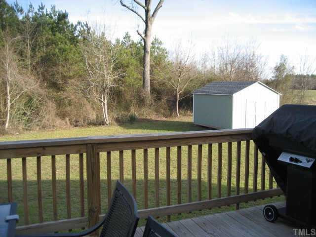 665 Cole Road Clayton, NC 27520 - Photo 11 of 12 Large deck and paito overlooking the wooded private back yard, the storage building and play equipment stay. Other